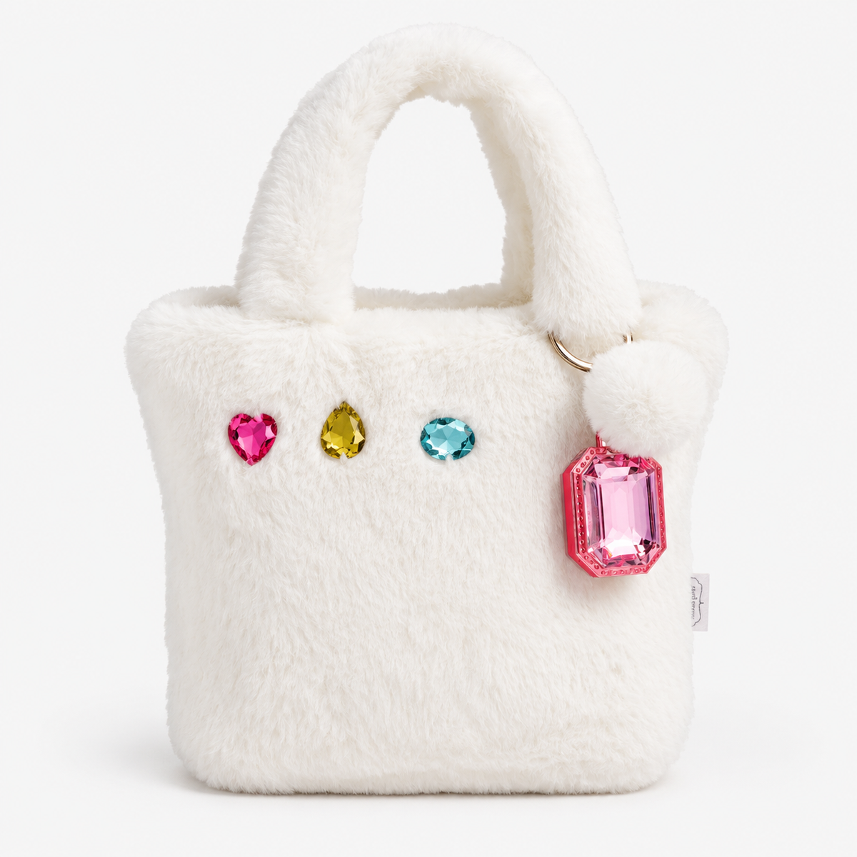 White faux fur mini tote bag with colorful crystal embellishments and fluffy pom-pom lip gloss keychain
