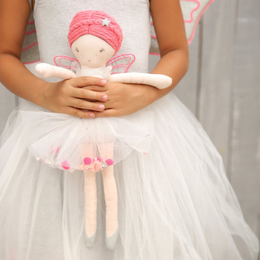 Child holding a handmade Neon Fairy Linen Doll during imaginative play
