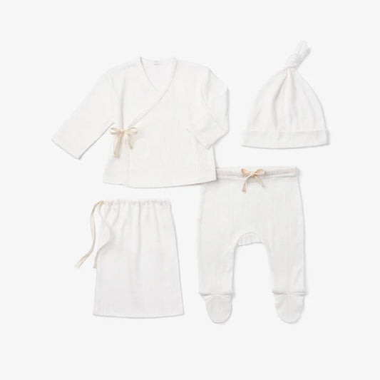 Four-piece white cotton knit newborn take-me-home set displayed together on white background