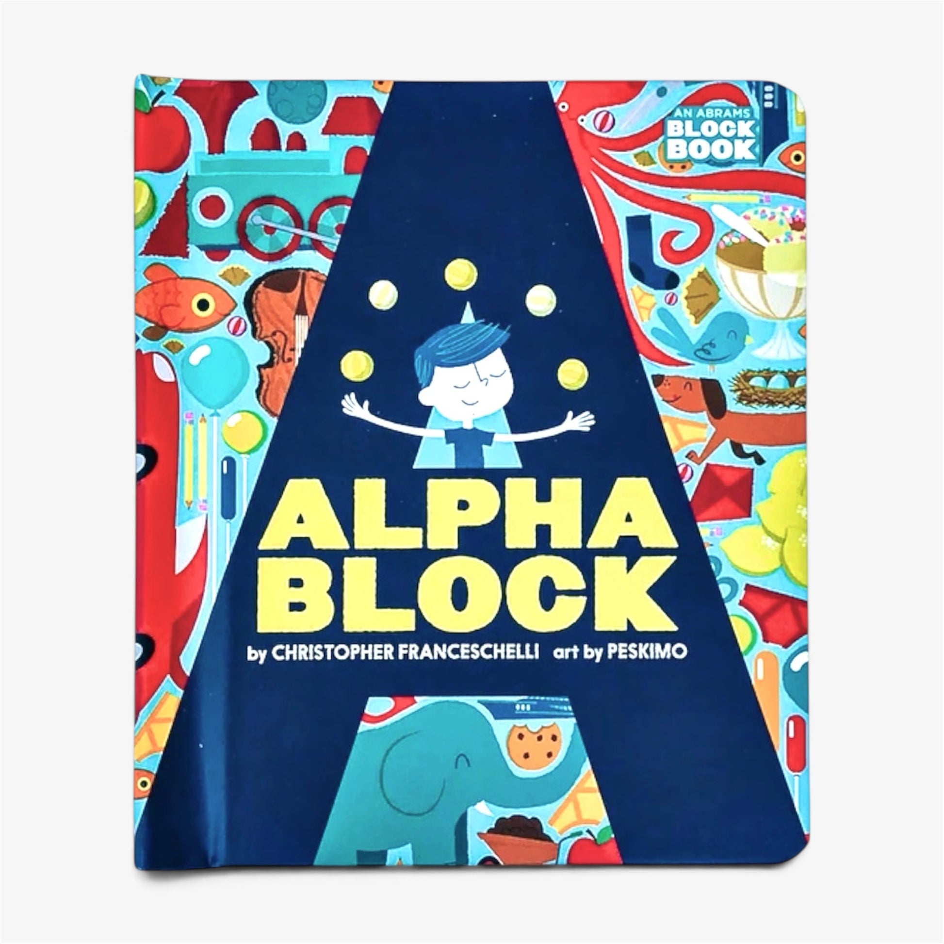 Children's block book titled 'Alpha Block' by Christopher Franceschelli and Peskimo, featuring a colorful illustrated cover with a large dark blue central triangle and playful cartoon graphics.