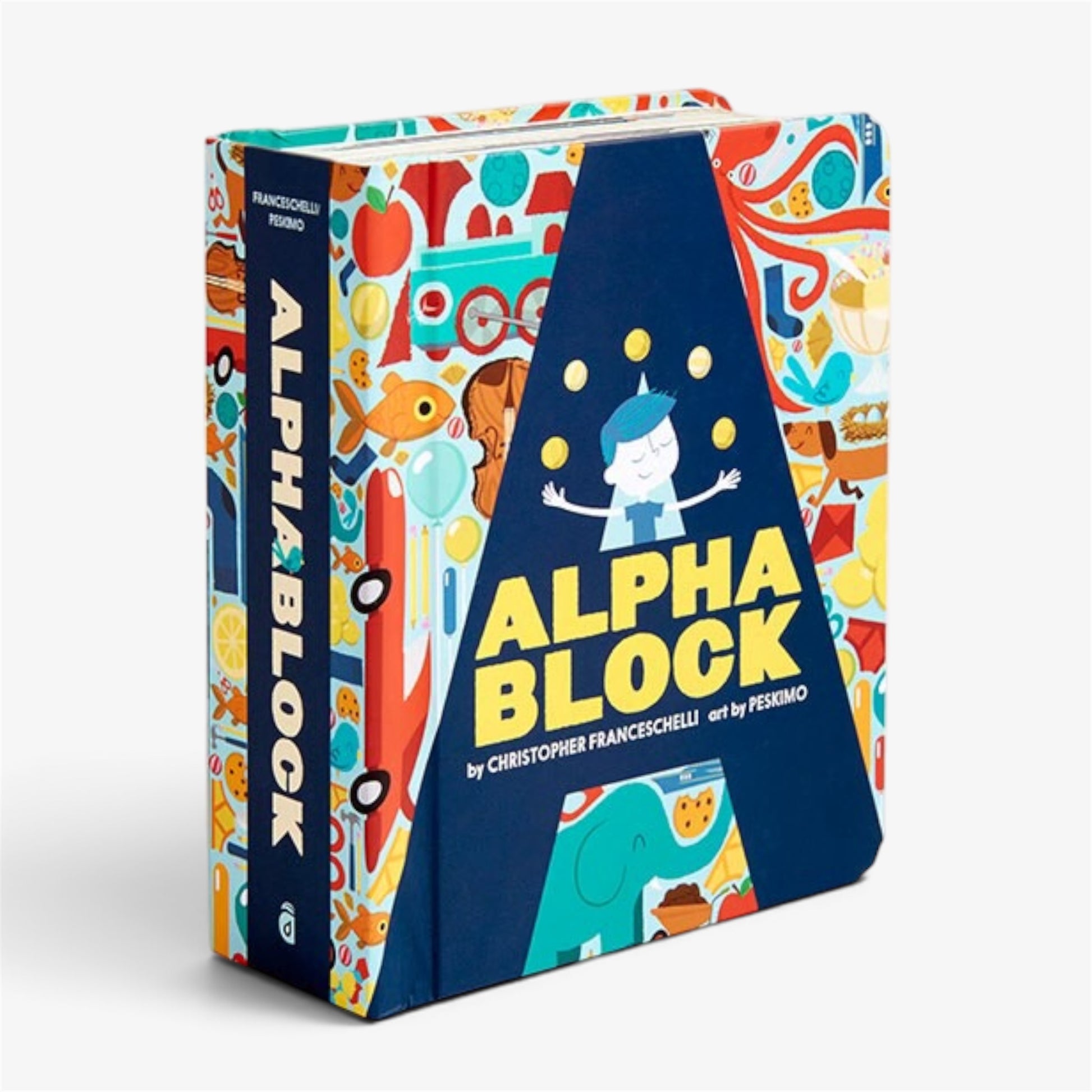The book 'Alpha Block' by Christopher Franceschelli and Massimo Peskino, featuring a colorful, playful cover design with a large blue triangular section and various cartoon illustrations, shown on a light gray background.