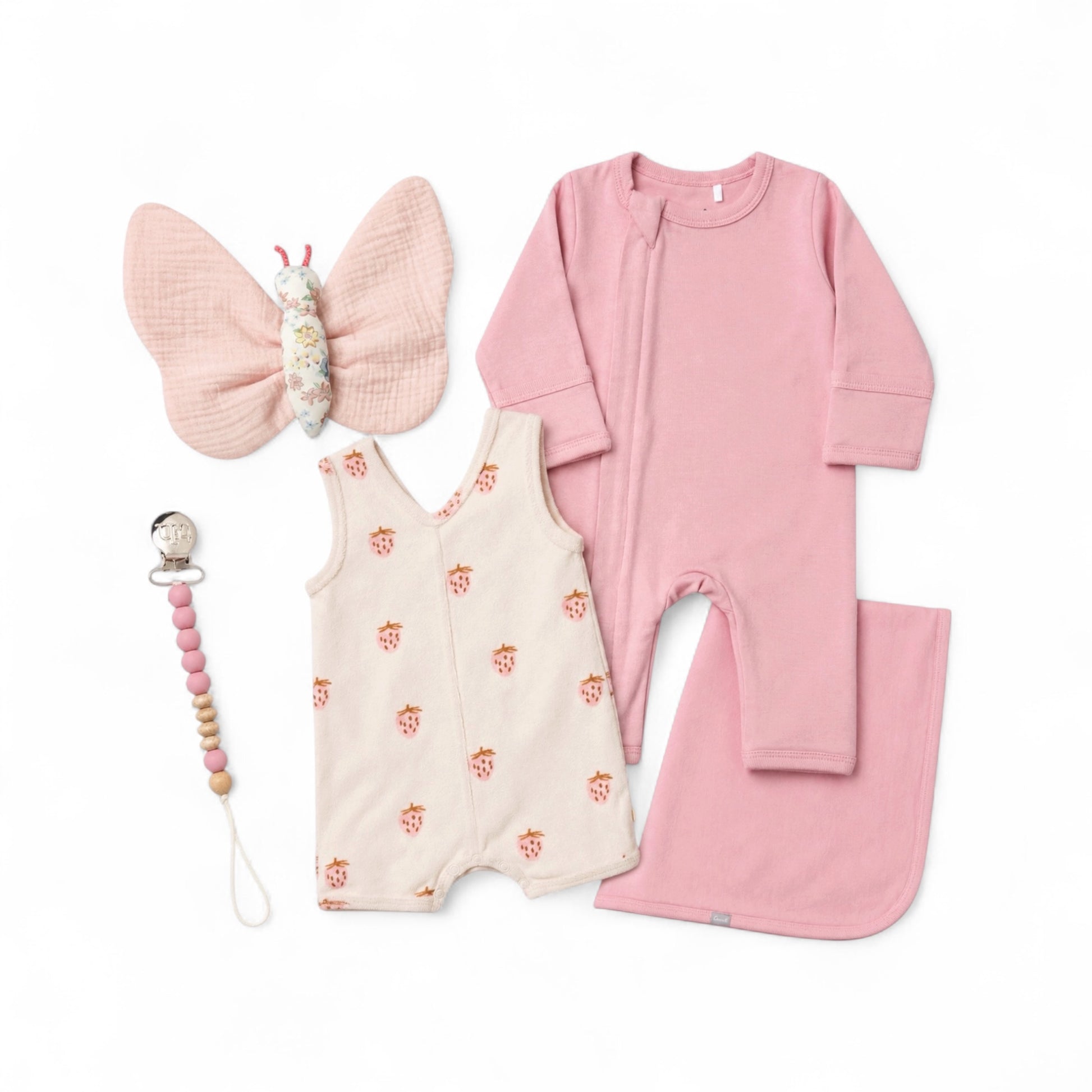 Blush pink baby girl gift set with romper, strawberry romper, blanket, butterfly plush toy, and pacifier clip.