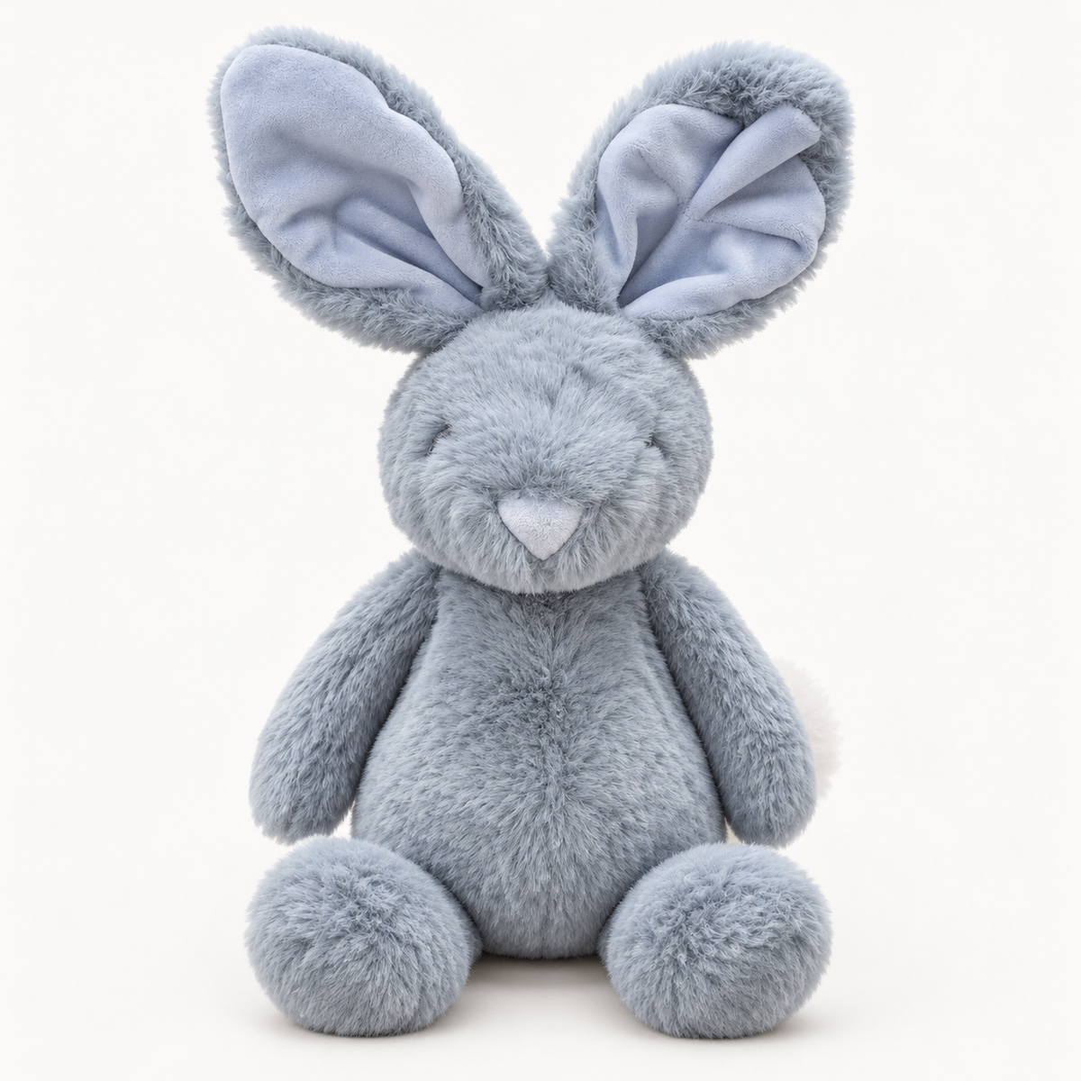A plush stuffed bunny toy in a soft light blue-gray color, featuring large floppy ears with pale blue inner linings, a small stitched smile, and round feet, photographed against a clean white background.