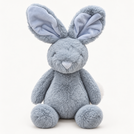 A plush stuffed bunny toy in a soft light blue-gray color, featuring large floppy ears with pale blue inner linings, a small stitched smile, and round feet, photographed against a clean white background.