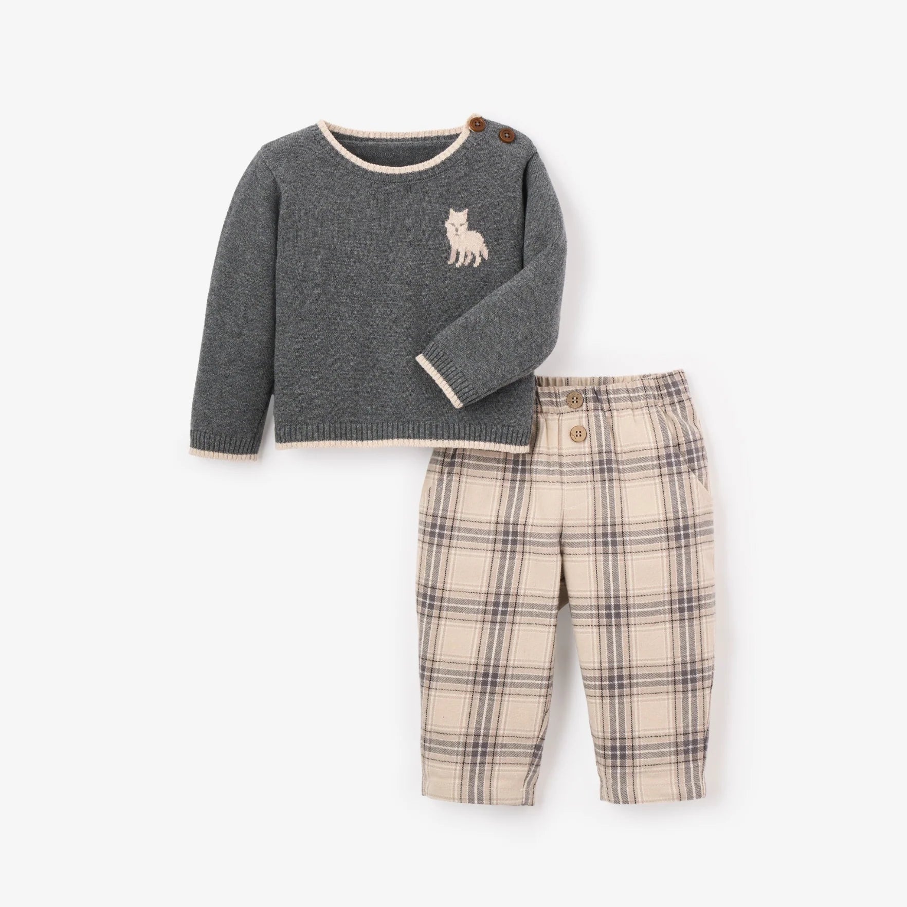 Children's sweater and plaid pants set on a white background