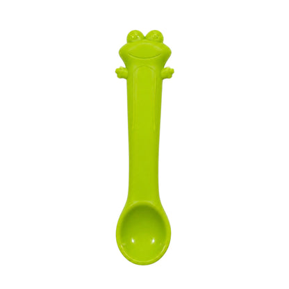 Green frog-shaped silicone baby spoon on white background.