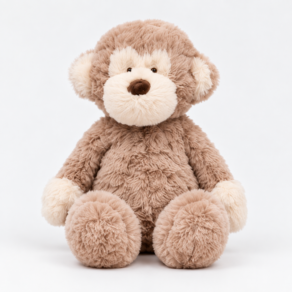 Felix plush monkey sitting front view with taupe-brown fur and cream face and hands against white background