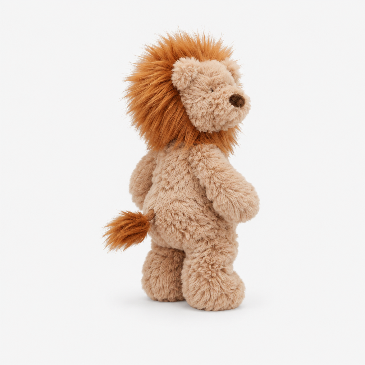 A plush lion toy standing upright, shown from the back on a clean white background. The toy has a light tan body with a fluffy orange-brown mane and tail, and a small dark embroidered nose.