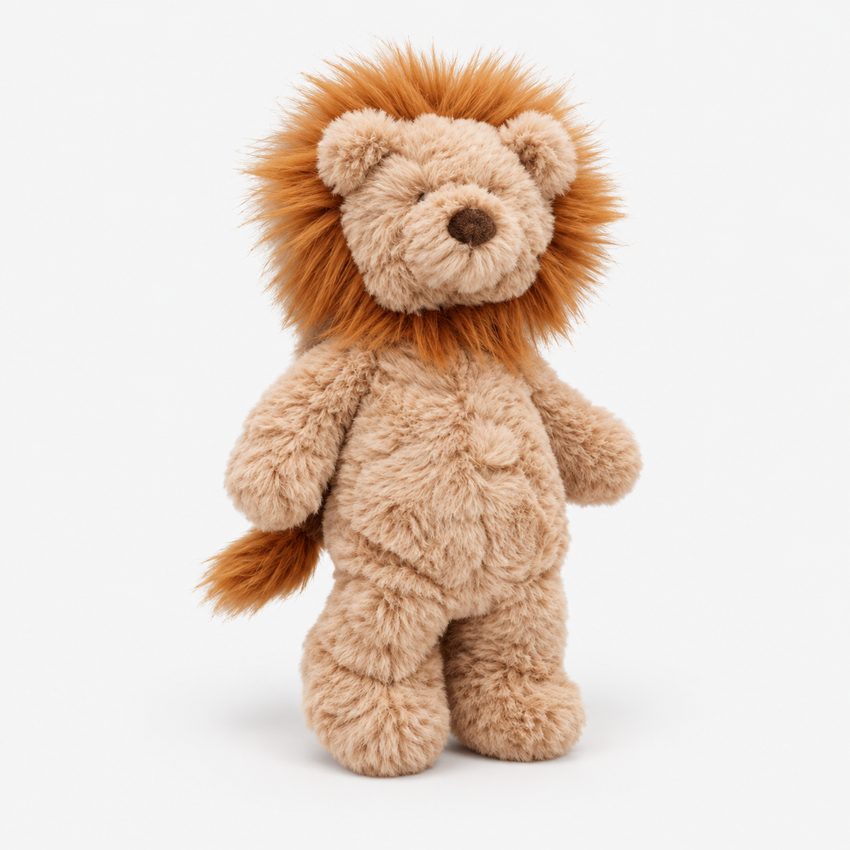 A plush lion toy standing upright against a clean white background. The stuffed animal has a light tan body with a fluffy orange-brown mane and tail, a dark brown embroidered nose, and small embroidered eyes.