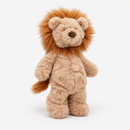 A plush lion toy standing upright against a clean white background. The stuffed animal has a light tan body with a fluffy orange-brown mane and tail, a dark brown embroidered nose, and small embroidered eyes.