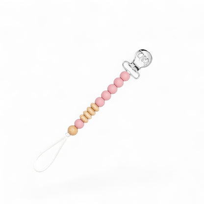 Pink beaded baby pacifier clip with natural wood beads, silver clip, and white loop.