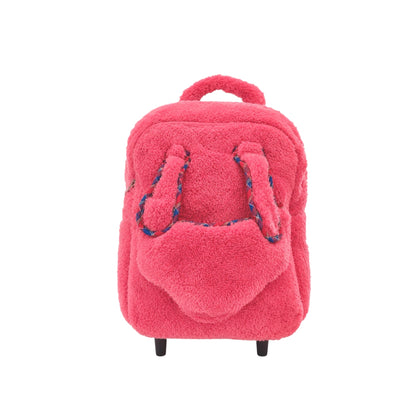 Front view of pink plush kids rolling backpack with fuzzy texture, front pocket, top handle, black feet, and patterned strap details on a white background.