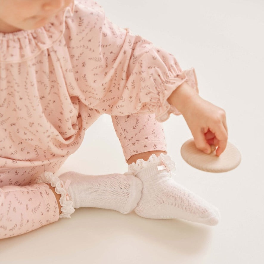 Baby wearing the blush wildflower bamboo ruffle top and matching leggings