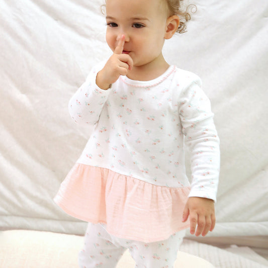 Baby girl wearing floral organic cotton outfit with matching leggings