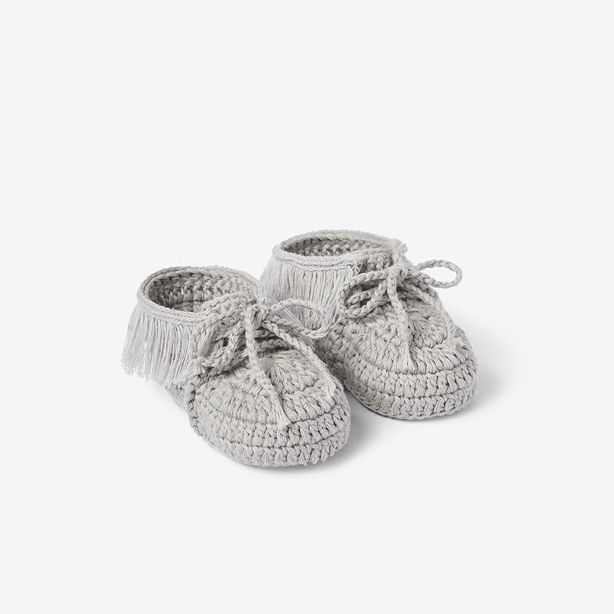 Pair of gray hand-crocheted cotton moccasin baby booties on white background