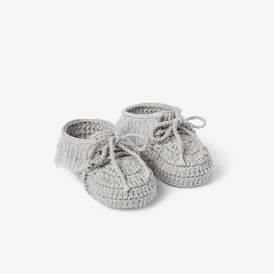 Pair of gray hand-crocheted cotton moccasin baby booties on white background