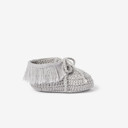 Side view of a gray cotton knit moccasin baby bootie on white background