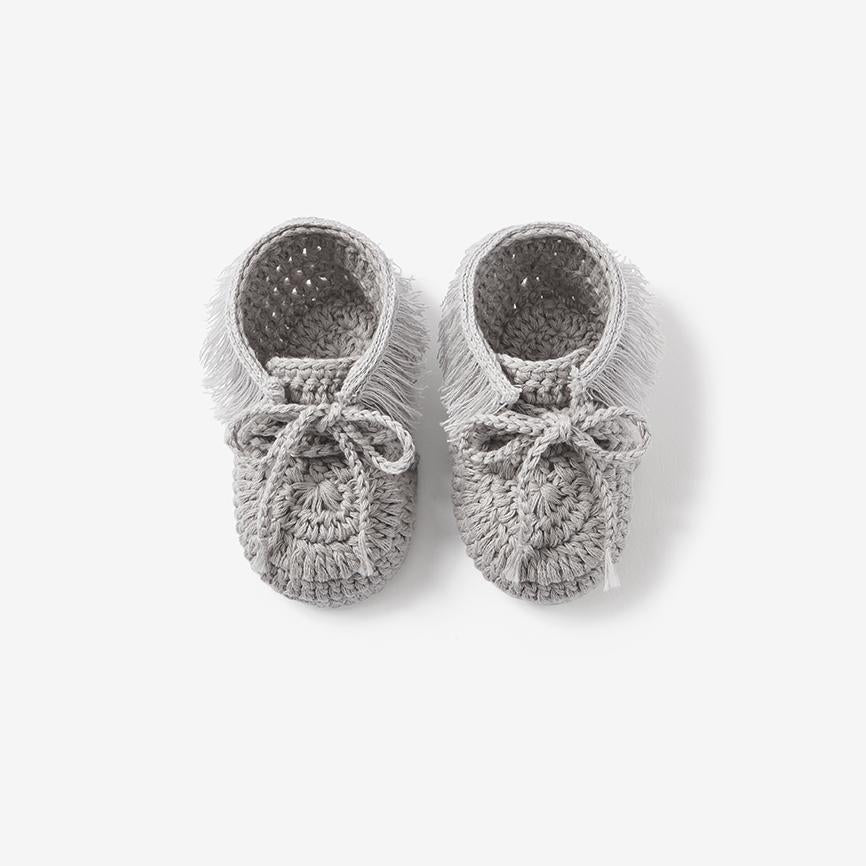 Top view of gray hand-crocheted moccasin baby booties on white background