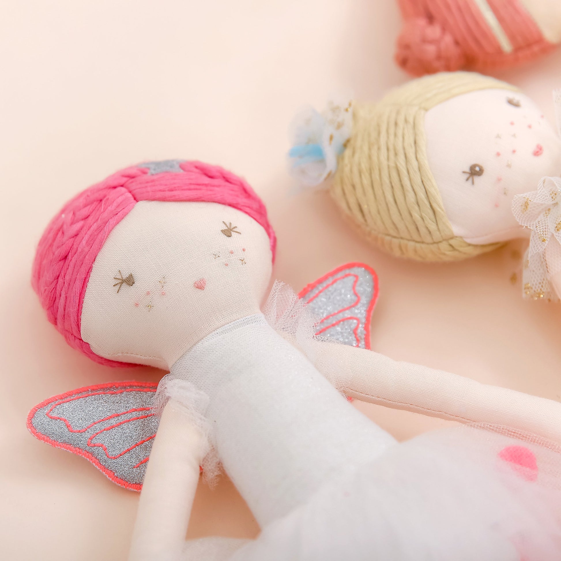Close-up of Neon Fairy Linen Doll featuring sparkly wings and handcrafted details