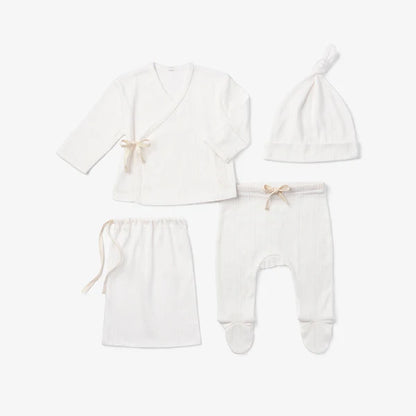 Four-piece white cotton knit newborn take-me-home set displayed together on white background